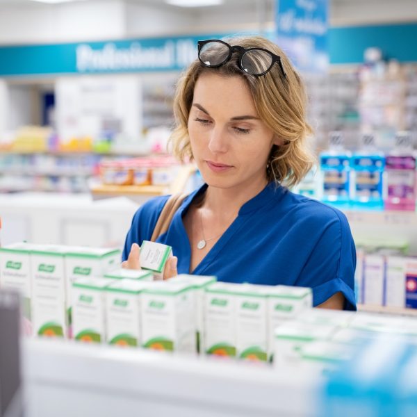 Woman choosing product in pharmacy Woman choosing product in pharmacy